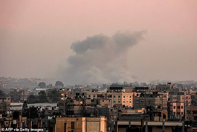 A deadly attack has killed 21 Israeli soldiers in Gaza, the country's military said.  Pictured: Smoke rising over Gaza in the early hours of Tuesday morning