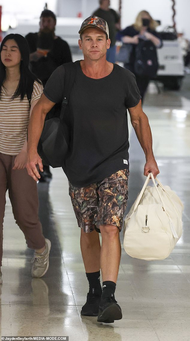 AFL legend Ben Cousins, 45, (pictured) looked happy and healthy as he landed at Sydney Airport on Saturday