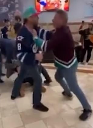 Both fans got into it after pulling out of the group fight