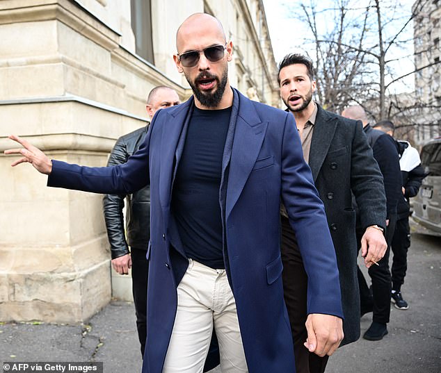 Andrew Tate (L) and Tristan Tate (R) walk away from the Bucharest Court of Appeal on December 22