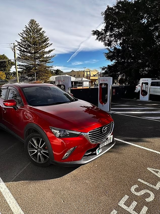 An electric vehicle being charged at an EV charging station (stock image)