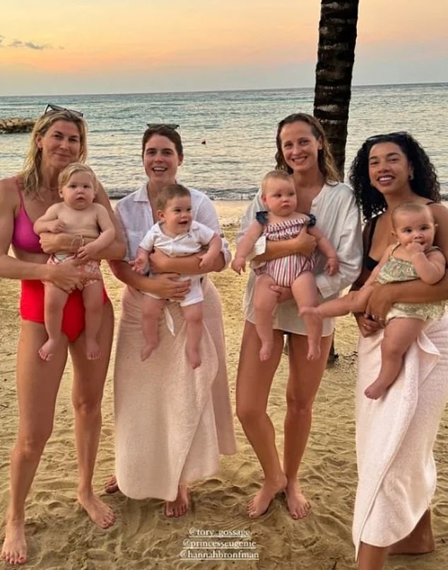 Hello 2024!  Princess Eugenie, 33, (second from left) holds six-month-old Ernest as she poses for a sunset photo with friends on a beach in Jamaica