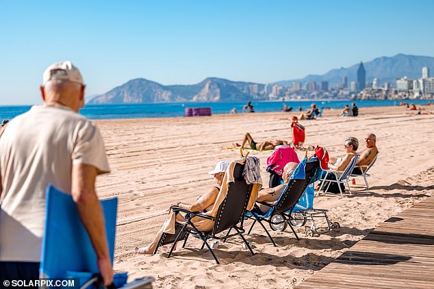 Holidaymakers enjoy the extraordinary January temperatures on the beach of Benidorm