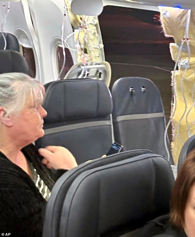 Passengers on an Alaska Airlines flight look at the hole in the side of the plane: a Boeing 737 Max 9 on January 5