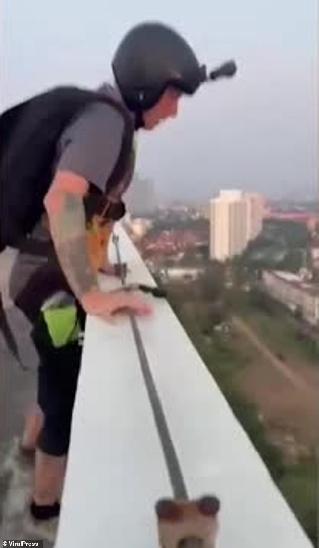 Footage shows the Brit performing a similar stunt a few days earlier (pictured) when he jumped from a dangerously low apartment building in Pattaya