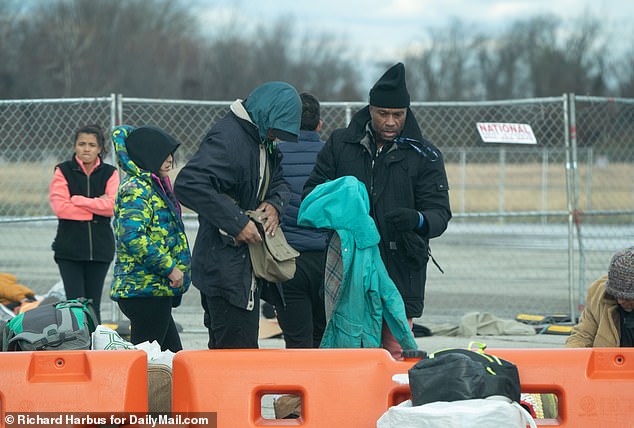 Mirgants pick out clothes at Floyd Bennett Field