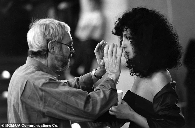 On Monday, the legendary Cher (R, pictured in 1987) tweeted a tribute to her Moonstruck director Norman Jewison (L) following his death, aged 97, at his Los Angeles home last Saturday.