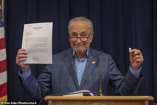 Senate Majority Leader Chuck Schumer holds a Zyn bag during Sunday's announcement