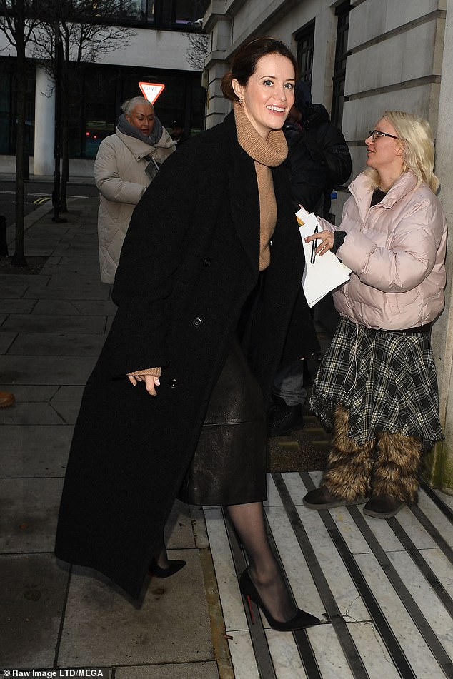 The Crown star, 39, put on a leggy show in a black leather midi skirt which she paired with sheer tights and stiletto heels