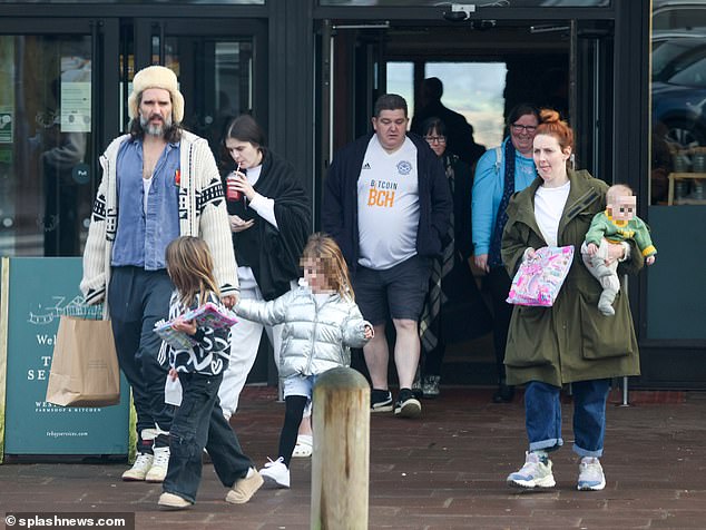 The comedian, 48, was spotted at swanky Tebay services on the M6 ​​in Cumbria with wife Laura Gallacher, 36, and their children (pictured)