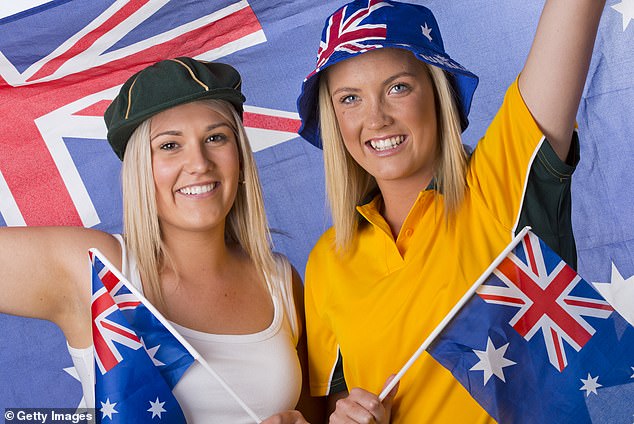 Many supporters felt that sport and politics do not mix, with numerous messages saying 'Happy Australia Day' in response (pictured two women decked out in green and gold, holding Australian flags)