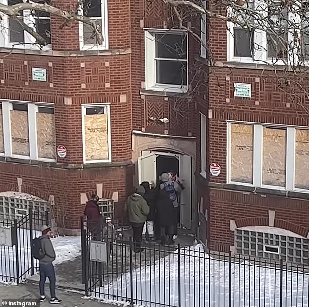 Video from across the street showed dozens of people breaking into a three-story building on Essex Avenue on Chicago's South Shore on Sunday