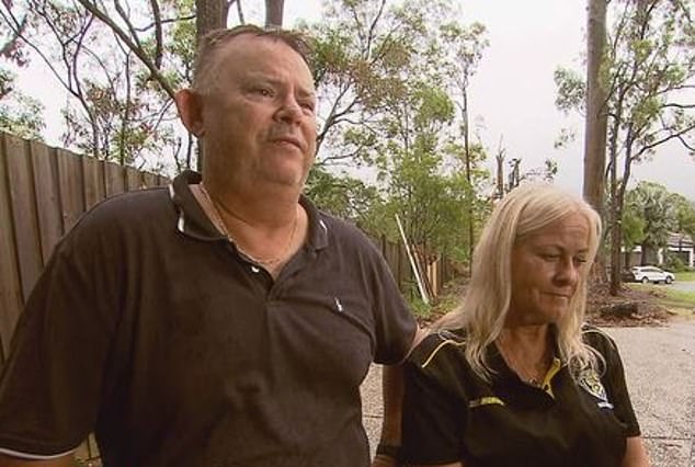 Parents of five, Rodney and Karen Jackson (pictured), fear a huge gum tree looming over their Upper Coomera home could kill them if it fell during a storm