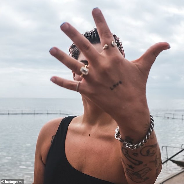 Brodie shared a photo of herself blocking her face while showing off the engagement ring with a large diamond insert.  In the caption, she wrote 