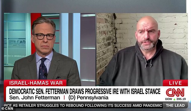 Democrat Senator John Fetterman (right) broke with his party and argued that the border crisis threatens to destroy the American dream when he spoke with CNN's The Lead host Jake Tapper (left) on Friday.