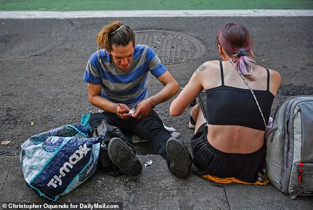 Fentanyl addicts who interact with first responders in downtown Portland over the next 90 days will be connected to resources including drug treatment programs.  Pictured: Two people sat on the streets of Portland on August 11, openly using drugs