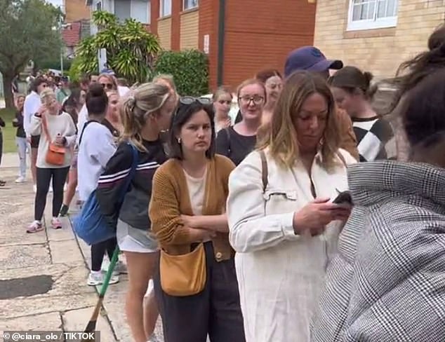 Potential tenants wait outside an apartment inspection in Randwick