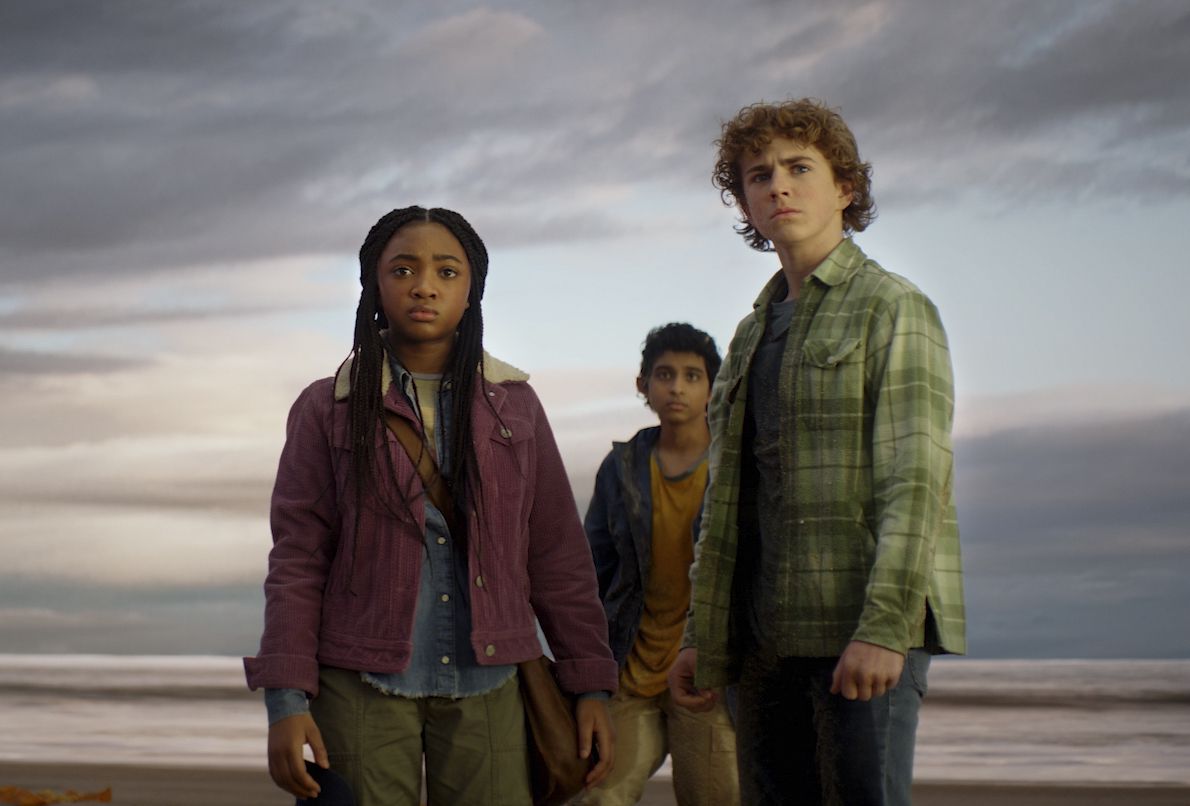 Percy (Walker Scobell), Annabeth (Leah Sava Jeffries) and Grover (Aryan Simhadri) stand on a beach