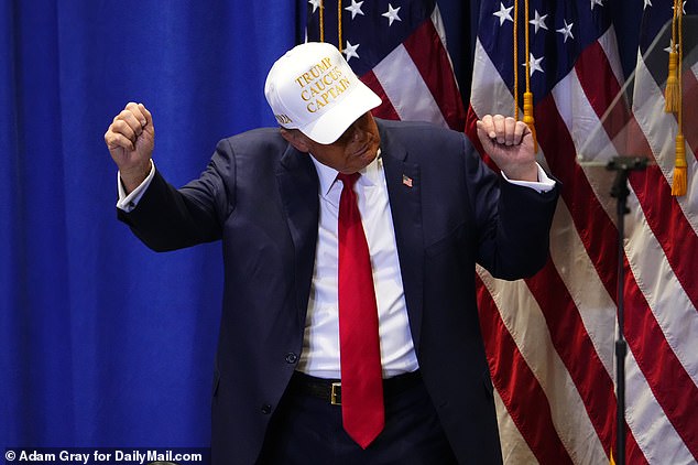 Former President Donald Trump does a dance and wears one of his Trump Caucus Captain hats.  The Trump campaign handed out the white and gold hats to their caucus captains, with these individuals making a pitch to voters across the state on caucus night