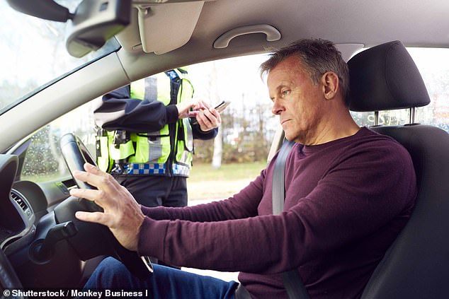 Motorists have been urged to drive safely over the Australia Day long weekend or face double demerits and risk hefty fines.  In the photo, a man sits in a car after being stopped by a police officer