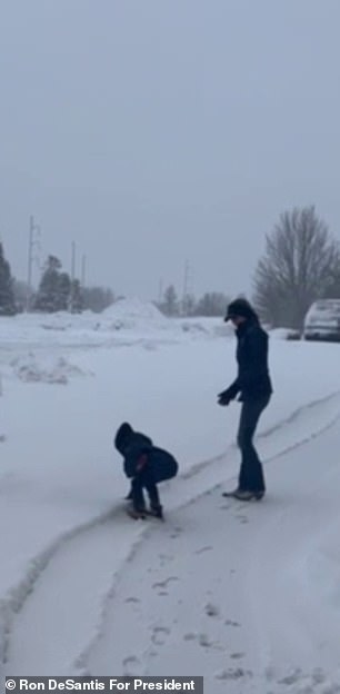 Mason DeSantis, give, makes a snowball during a winter storm in Des Moines, Iowa