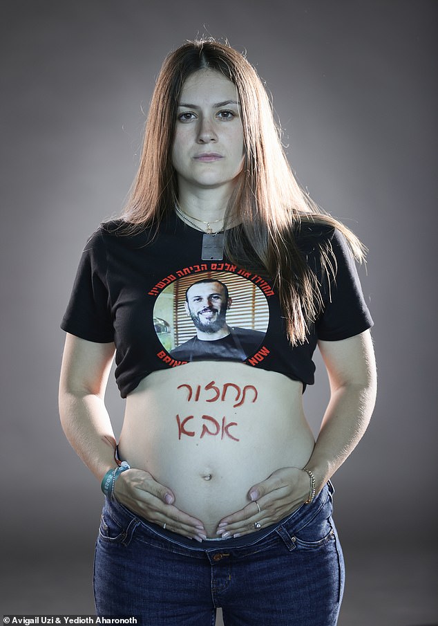 Michal Lobanov (pictured with the words 'Come back daddy' written on her stomach), 28, said she was left 'depressed', 'alone' and full of 'hatred' towards Hamas after they kidnapped her 32-year-old husband, Alexander