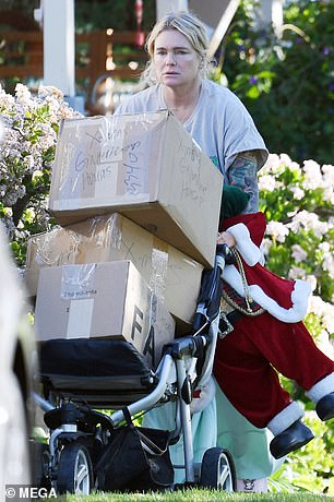 She started by dragging several boxes, which appeared to be Christmas decorations, onto a hand truck before taking her dog for a walk