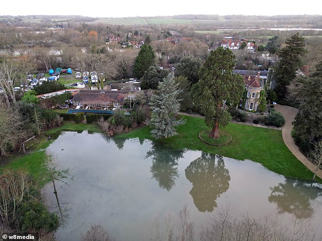 George Clooney was among the celebrities whose country homes were hit by Storm Henk, as flooding continues to cause chaos.  In the photo: flooding in the gardens of his country house