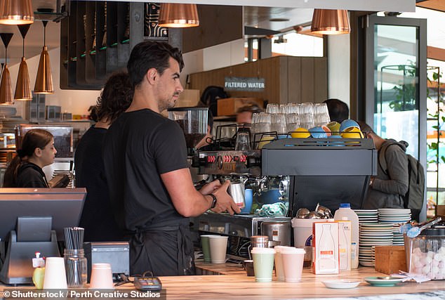 You can leave a little something when you pick up your flat white without causing offense in Australia.  However, no one will be mad if you don't.  Pictured is a barista making coffee in Perth