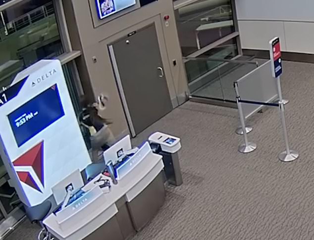 Kyler Efinger, 30, breached security at Salt Lake City International Airport before boarding a plane engine and dying on January 1.  CCTV footage shows Efinger ran to a closed gate door, tried to open it and then started hitting a nearby gate with his shoes.  window