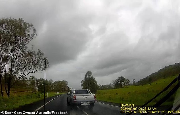 A silver Mitsubishi Triton was seen overtaking a car towing a caravan in rainy conditions on the D'Aguilar Highway, northwest of Brisbane, Queensland, on New Year's Day.