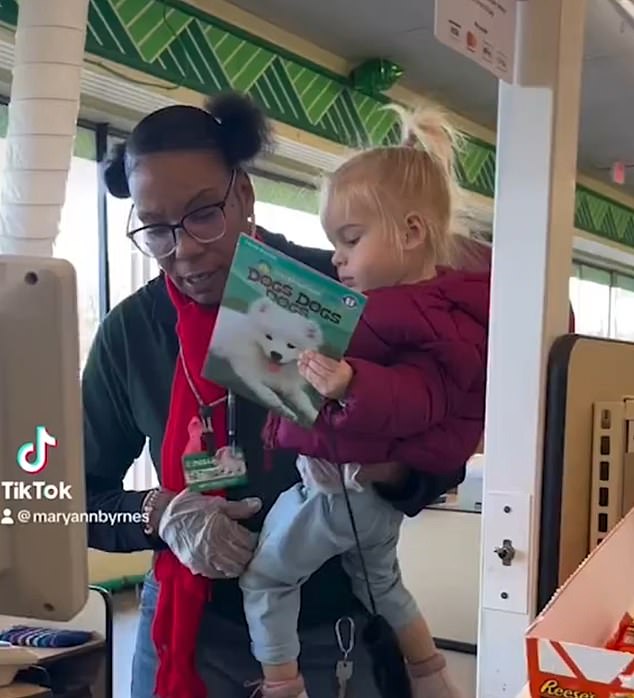 Mary-Ann Byrnes with her child at the checkout.  She said: 'My daughter is at a toddler age where she gets restless and wants to be picked up all the time'