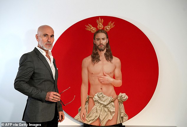 The poster, designed by Sevillian artist Salustiano Garcia (pictured, left), shows Christ after his resurrection from the dead, half-naked in front of a blood-red background