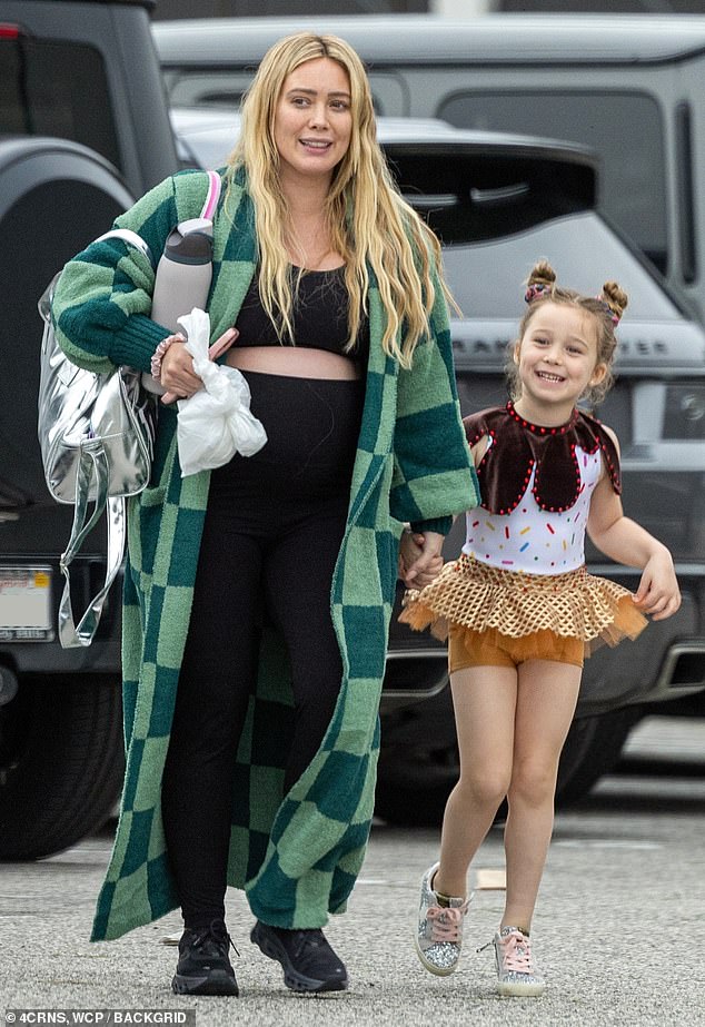 Hilary Duff showed off the top of her growing baby bump as she took her daughter Banks, five, to a dance class in Los Angeles on Wednesday