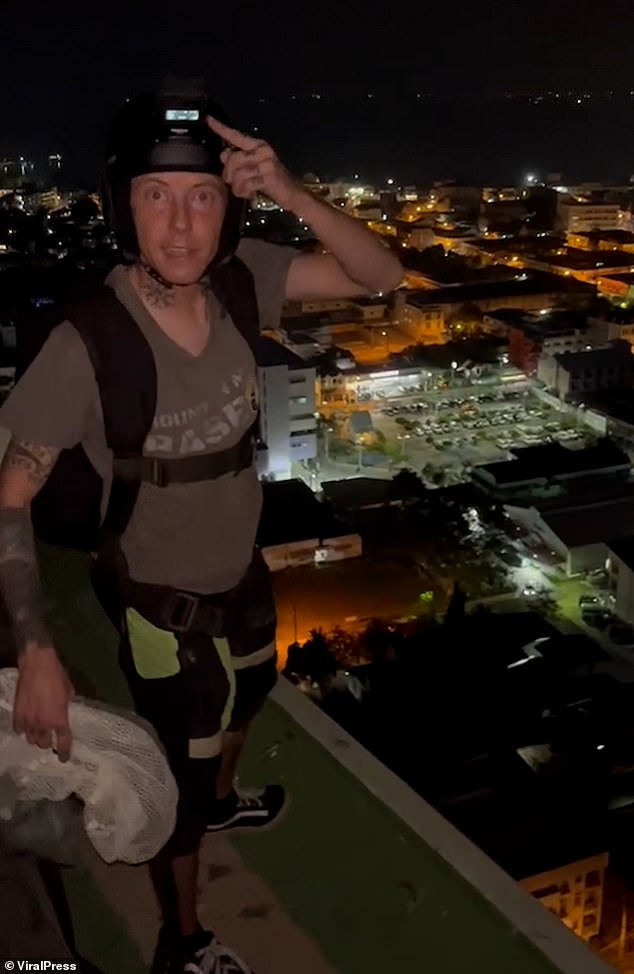 Nathy Odinson, 33, from Huntingdon, Cambridgeshire, climbed to the 29th floor of a block of flats in the coastal town of Pattaya on Saturday evening before dying (pictured: moments before his death)