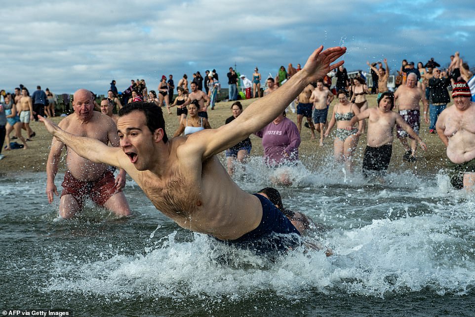 This swimmer looks ready for a dip in the icy waters of Boston Harbor as he rings in the New Year