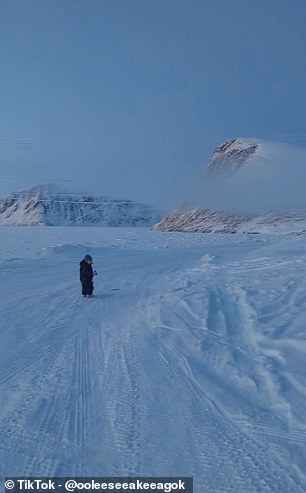 The youngster ventures into the snowy landscape