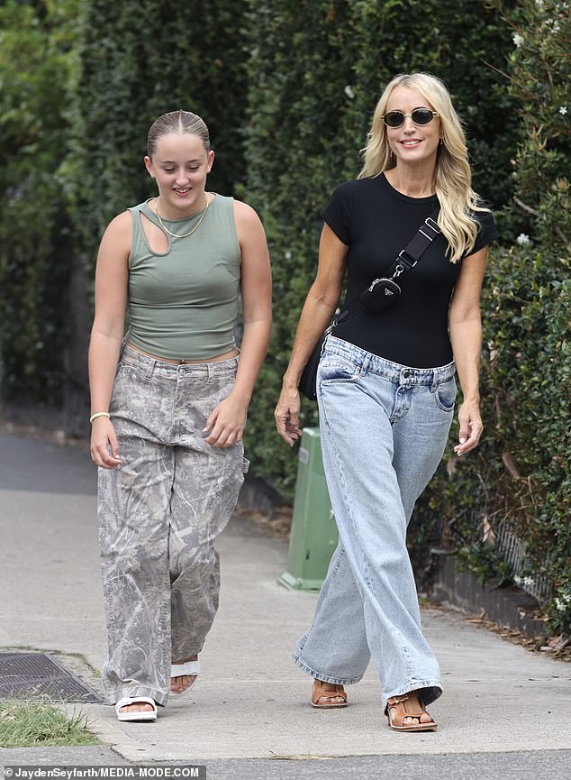 Jackie O Henderson looked stylish in trendy jeans as she celebrated her 49th birthday at a restaurant in Sydney's Bondi on Wednesday with her daughter Kitty