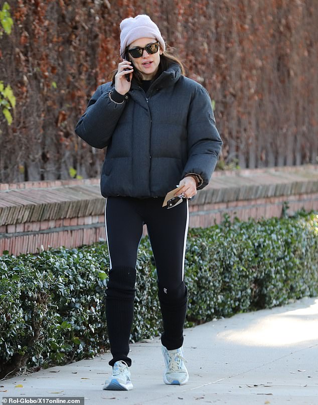 Jennifer Garner was spotted on a morning walk in Santa Monica on Tuesday.  The 51-year-old actress wore a cropped puffer jacket, leggings with white stripes down the sides and leg warmers for her solo outing