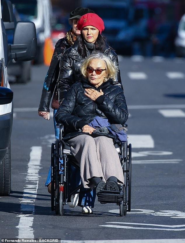 The legendary actress wore taupe cotton pants, a black puffer and black sneakers as she was rolled down the sidewalk