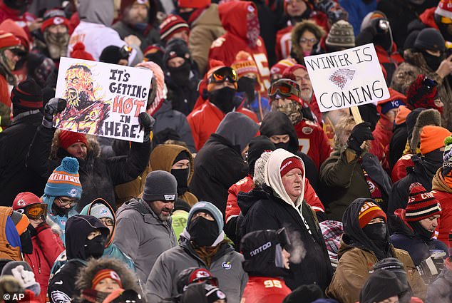 Chiefs fans who braved subzero temperatures celebrate after scoring a TD against the Dolphins