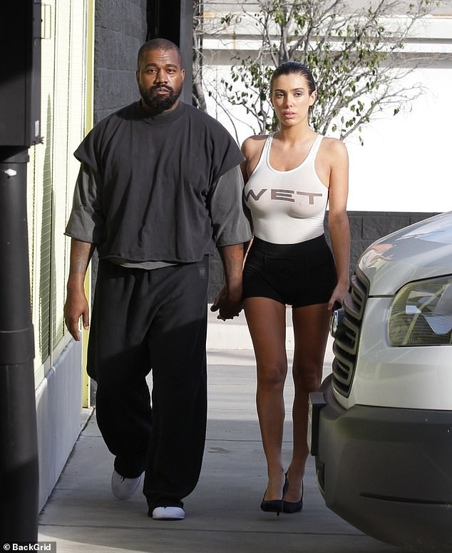 Kanye West's wife Bianca Censori showed off her bust as she and the rapper headed to a tanning salon in LA on Monday - before being confronted by an angry man on the street