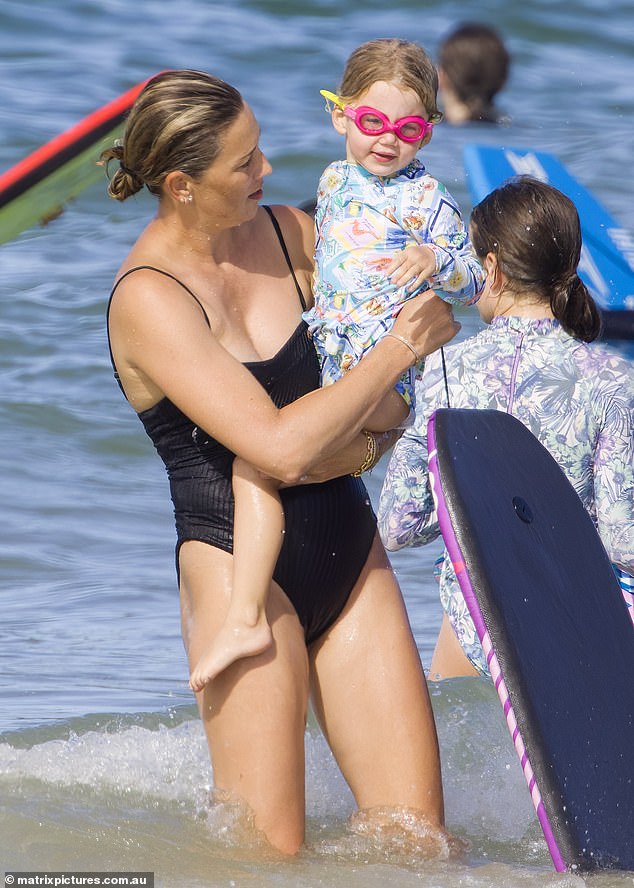 She looked every bit the doting mother as she showed Harper the ropes of water sports