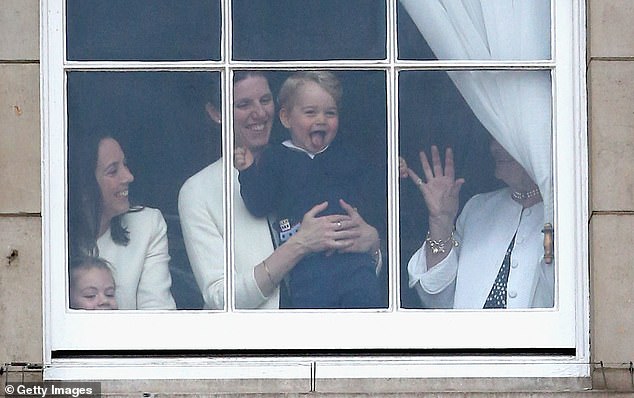 Prince George of Cambridge is held by his nanny Maria Teresa Turrion Borrallo as he waves from the window of Buckingham Palace while watching Trooping The Color on June 13, 2015 in London