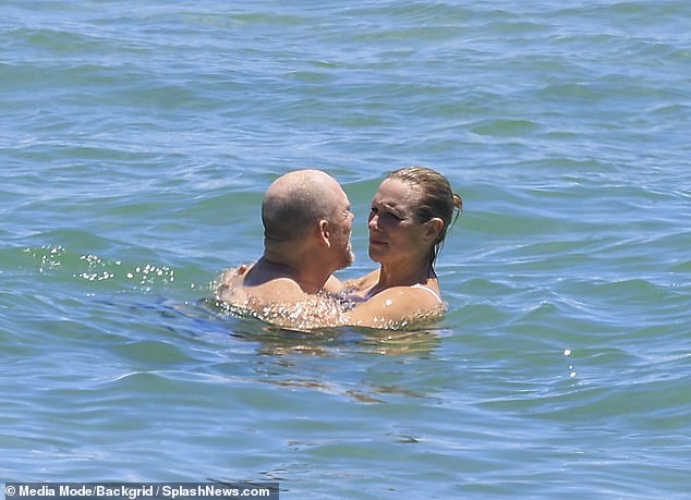 Zara and Mike cuddled together as they enjoyed floating in the sea while soaking up the January sunshine