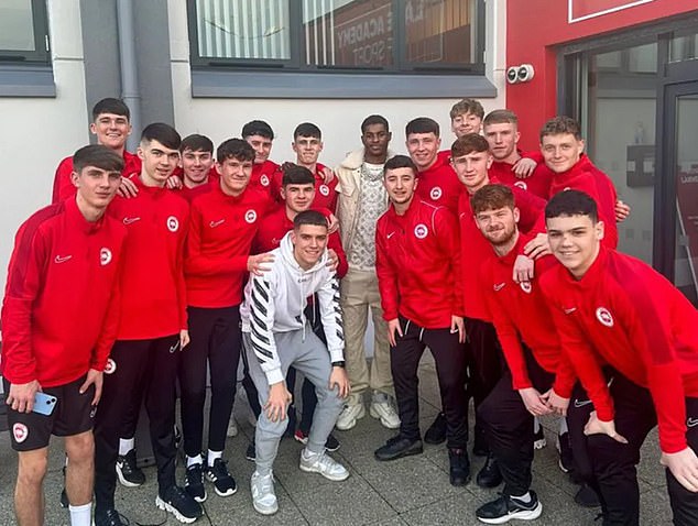 He posed for photos with some young players ahead of his boozy night out