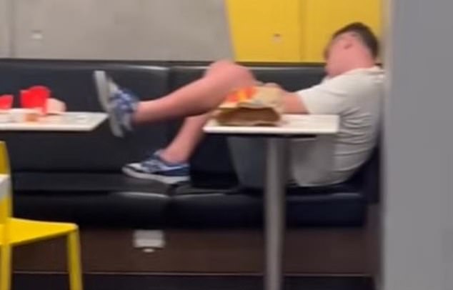 A Maccas customer was sleeping against a wall