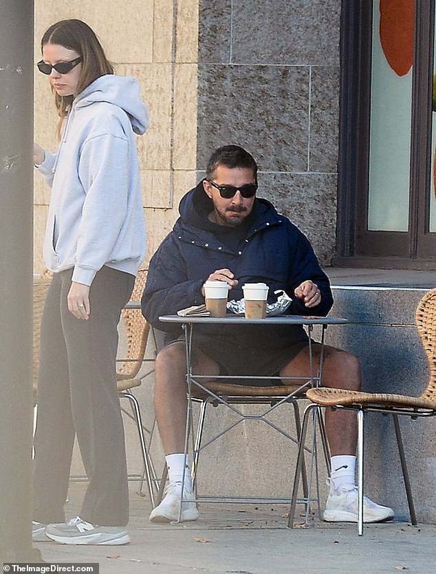 She was dressed casually in a white hoodie and black sweatpants, while the Transformers star wore charcoal gray shorts, a navy blue hoodie and a warmer blue sweater.