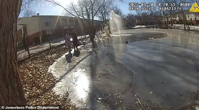 The officer is seen running through the snow and jumping over a fence toward the unknown boy, who can be heard crying in the video