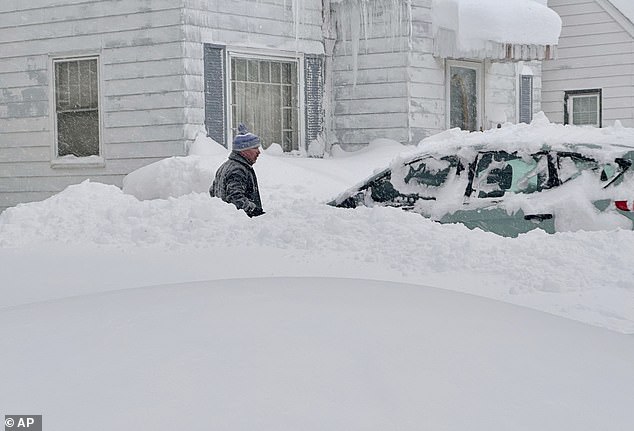 Patrick Sahr is out just after dawn shoveling snow from his car and driveway after at least 18 inches of new snow fell overnight — on top of the 10 feet that arrived last weekend in Buffalo, New York, on Jan. 17, 2024.